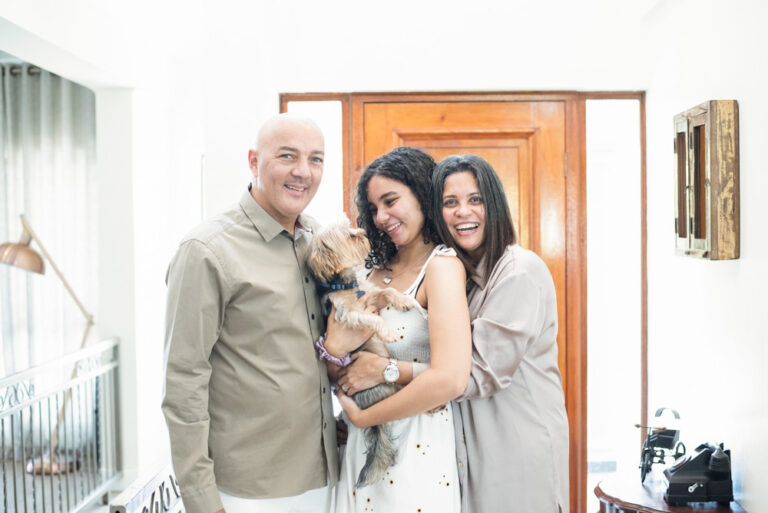 Family holding small dog in Ballito home during a photography session on the North Coast of Kwazulu Natal