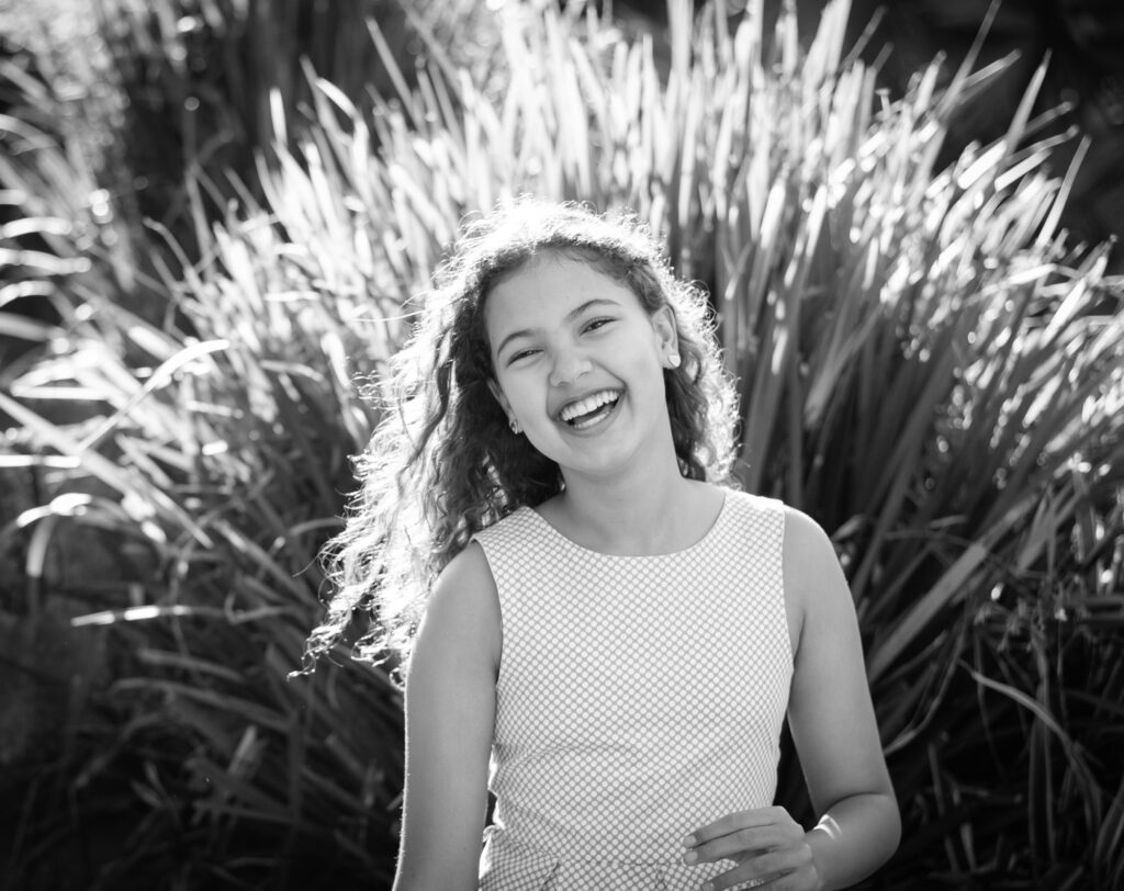 Monochrome portrait of young Girl with smiling Face and central Lighting taken at a Home in Durban North, South Africa