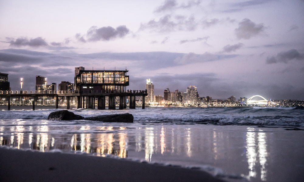 Durban Landscape Photography Print with Moses Mabhida stadium in the Background and Moyos Pier in the Foreground taken from Ushaka Beach